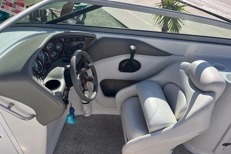 Slide: The Image of 2005 Crownline 266 BR boat interior with steering wheel and control panel. - 5