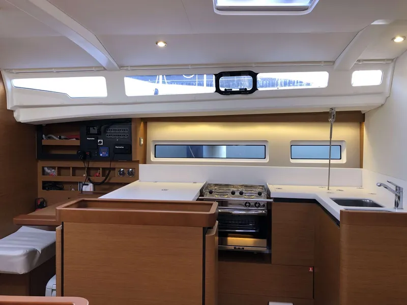 Slide: The Image of Interior of 2023 Jeanneau Sun Odyssey 440 yacht, featuring modern kitchen and sleek design. - 17