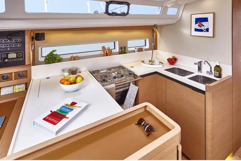 Slide: The Image of Modern kitchen interior of 2023 Jeanneau Sun Odyssey 440 yacht, featuring sleek design and amenities. - 5