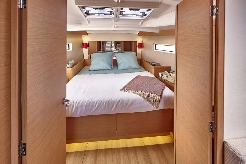 Slide: The Image of Luxurious cabin interior of 2023 Jeanneau Sun Odyssey 440 yacht with cozy bedding. - 6