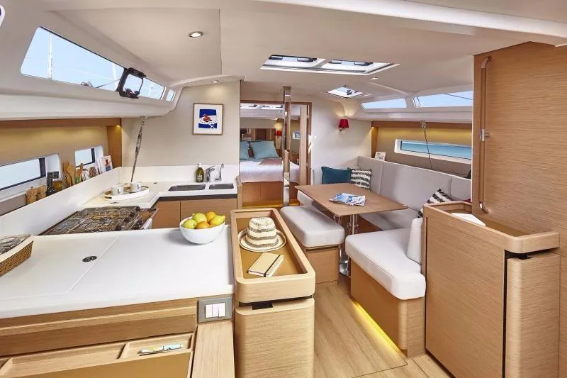 Slide: The Image of Luxurious interior of 2023 Jeanneau Sun Odyssey 440 yacht, featuring modern kitchen and dining area. - 8