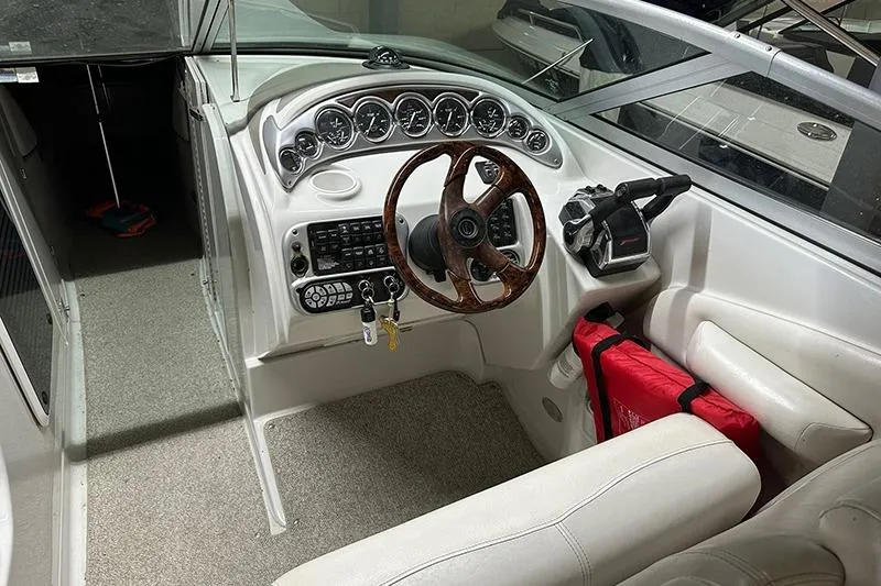 Slide: The Image of 2005 Crownline 316 boat cockpit with wood steering wheel and instrument panel. - 3