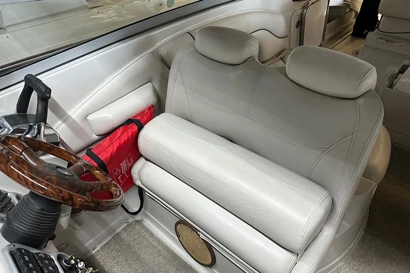 Slide: The Image of 2005 Crownline 316 boat interior with leather seating and wooden steering wheel. - 4