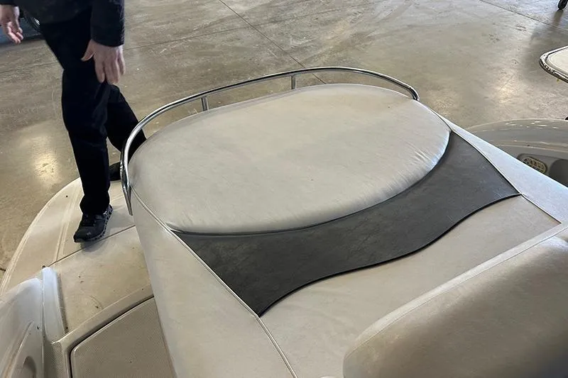 Slide: The Image of 2005 Crownline 316 boat interior with cushioned seating and metal railing. - 5