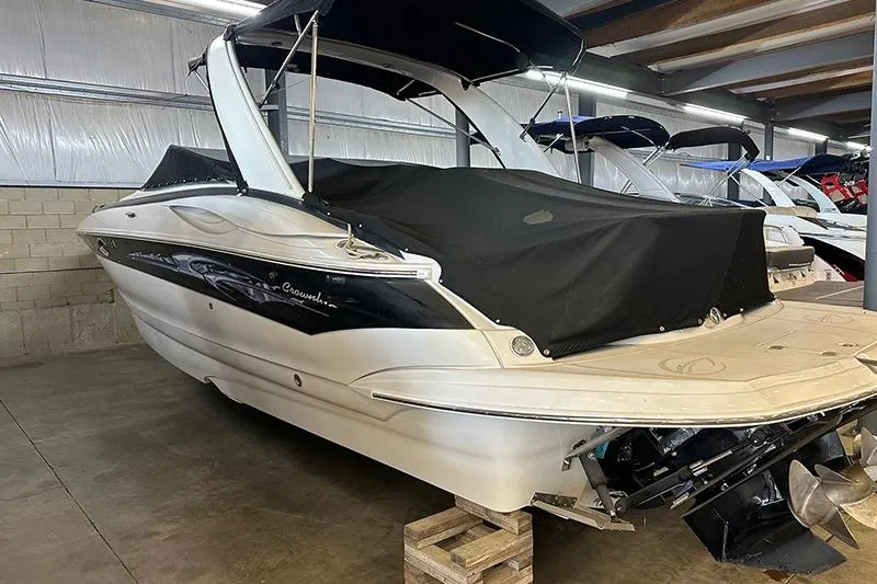 Slide: The Image of 2005 Crownline 316 boat in storage, covered and elevated on wooden blocks. - 6