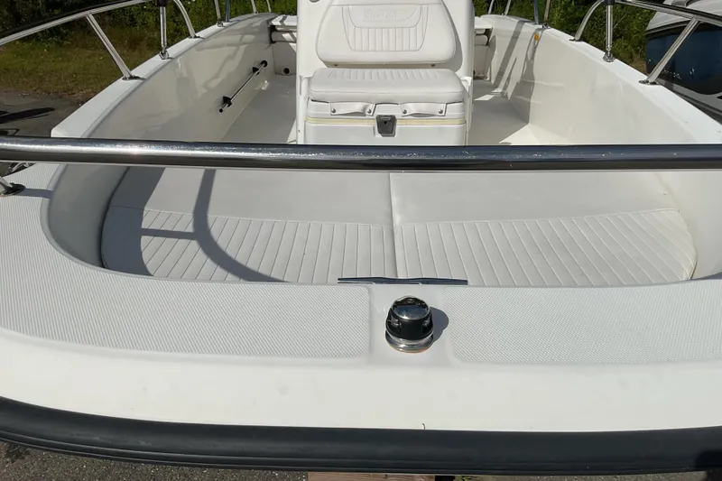 Slide: The Image of 2014 Boston Whaler 170 Dauntless boat interior with white seating and stainless steel railings. - 10