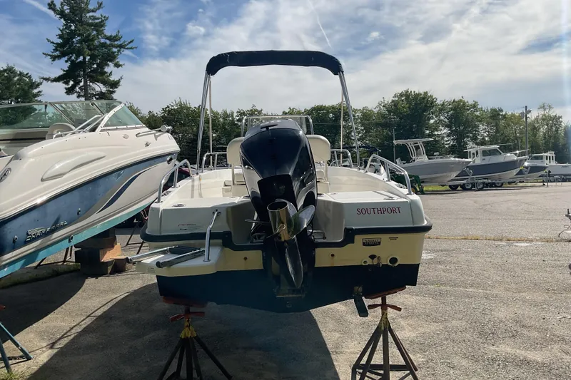 Slide: The Image of 2014 Boston Whaler 170 Dauntless boat on stands in a marina. - 5