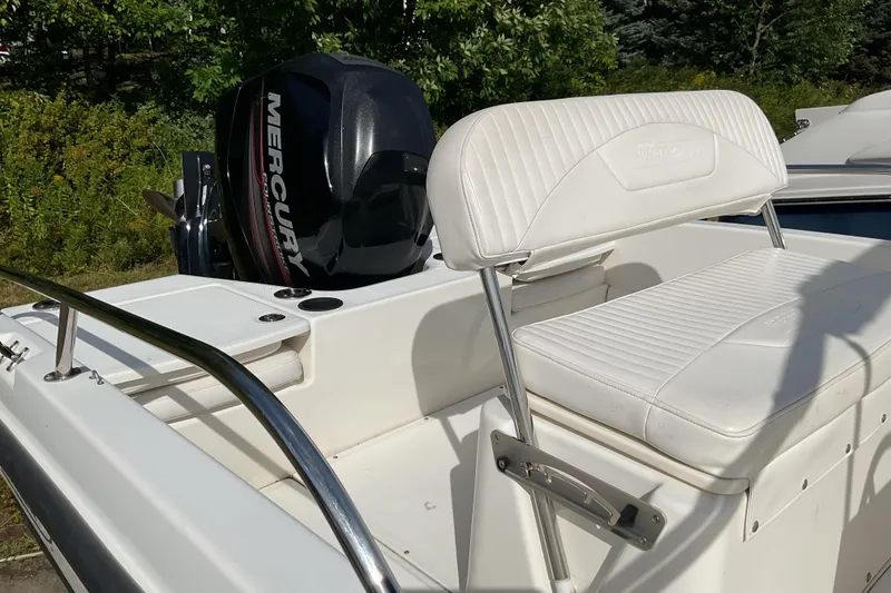 Slide: The Image of 2014 Boston Whaler 170 Dauntless boat with Mercury engine, white seating, and stainless steel rail. - 8