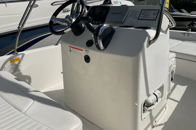 Slide: The Image of 2014 Boston Whaler 170 Dauntless boat console with steering wheel and Garmin navigation system. - 9