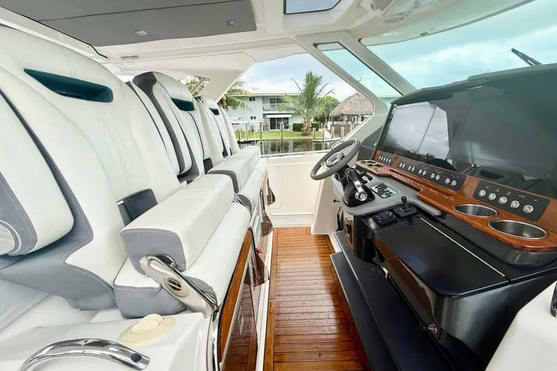Slide: The Image of 2019 Tiara Sport 38 LS yacht interior with luxurious seating and modern dashboard. - 12
