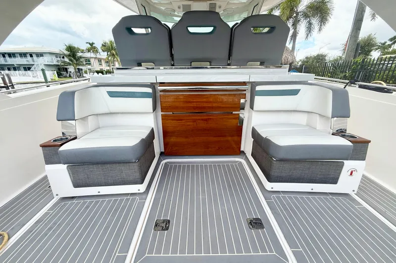 Slide: The Image of 2019 Tiara Sport 38 LS boat interior with seating and wooden cabinetry. - 14