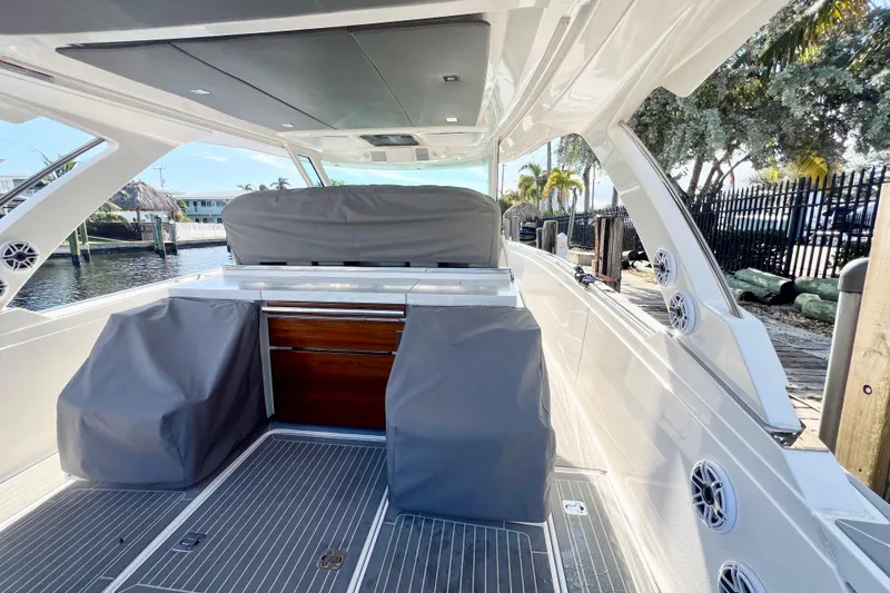Slide: The Image of 2019 Tiara Sport 38 LS boat interior with covered seating and sleek design. - 23