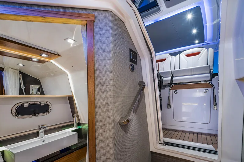 Slide: The Image of Manufacturer Provided Image: Interior of 2019 Tiara Sport 38 LS yacht, featuring modern bathroom and seating area. - 27