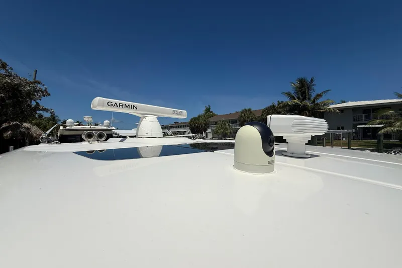 Slide: The Image of 2019 Tiara Sport 38 LS boat with Garmin radar and clear blue sky. - 33