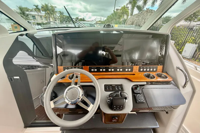 Slide: The Image of Helm of 2019 Tiara Sport 38 LS with modern controls and dual screens. - 9