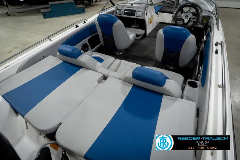Slide: The Image of 2006 Skeeter SL 190 boat interior with blue and white seating, steering wheel, and dashboard. - 12