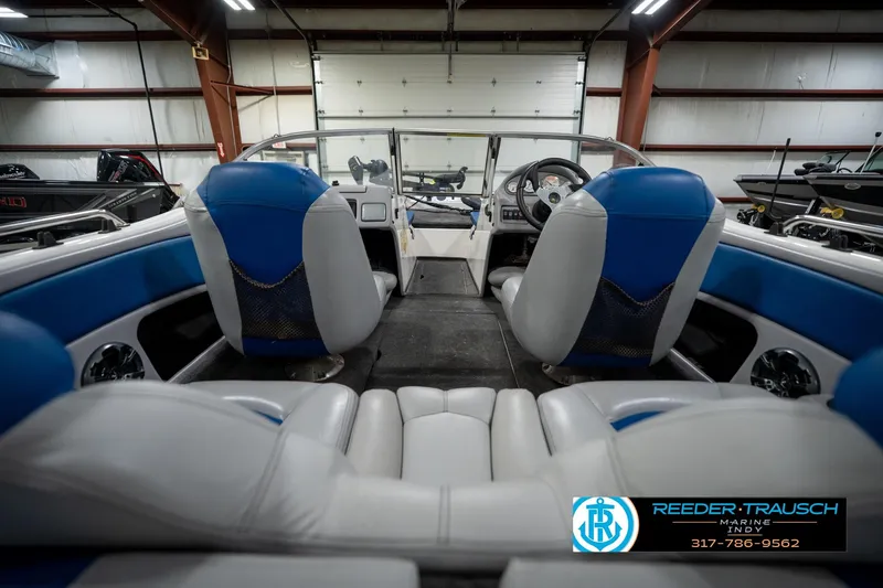 Slide: The Image of 2006 Skeeter SL 190 boat interior with blue and gray seating in a showroom. - 14
