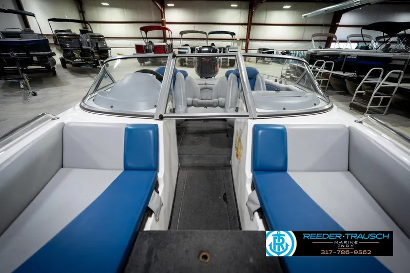 Slide: The Image of 2006 Skeeter SL 190 boat interior with blue and white seating in a showroom. - 17