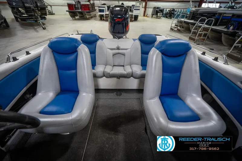 Slide: The Image of 2006 Skeeter SL 190 boat interior with blue and gray seating in a showroom. - 18