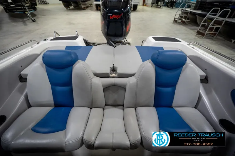 Slide: The Image of 2006 Skeeter SL 190 boat interior with blue and gray seating, displayed in a showroom. - 19