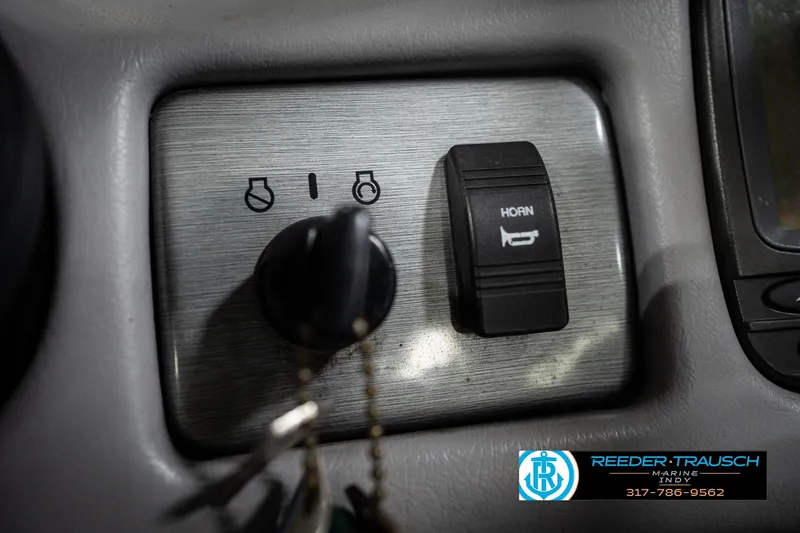 Slide: The Image of 2006 Skeeter SL 190 dashboard with horn switch and ignition key. - 33