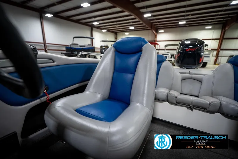 Slide: The Image of 2006 Skeeter SL 190 boat interior with blue and gray seating in a showroom. - 37