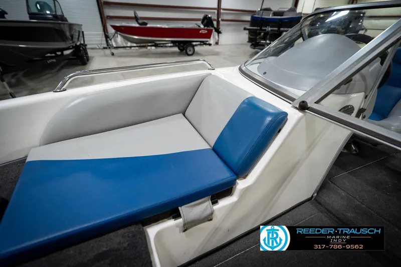 Slide: The Image of 2006 Skeeter SL 190 boat interior with blue and white seating in showroom. - 39
