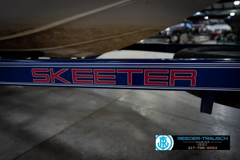 Slide: The Image of 2006 Skeeter SL 190 boat trailer with logo in a showroom setting. - 49