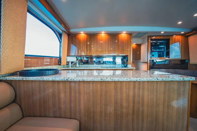 Slide: The Image of Luxurious interior of 2005 Viking 48 Convertible yacht with wood paneling and granite countertops. - 13
