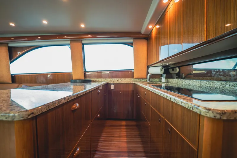 Slide: The Image of Luxurious kitchen interior of 2005 Viking 48 Convertible yacht with wood cabinetry and granite countertops. - 15