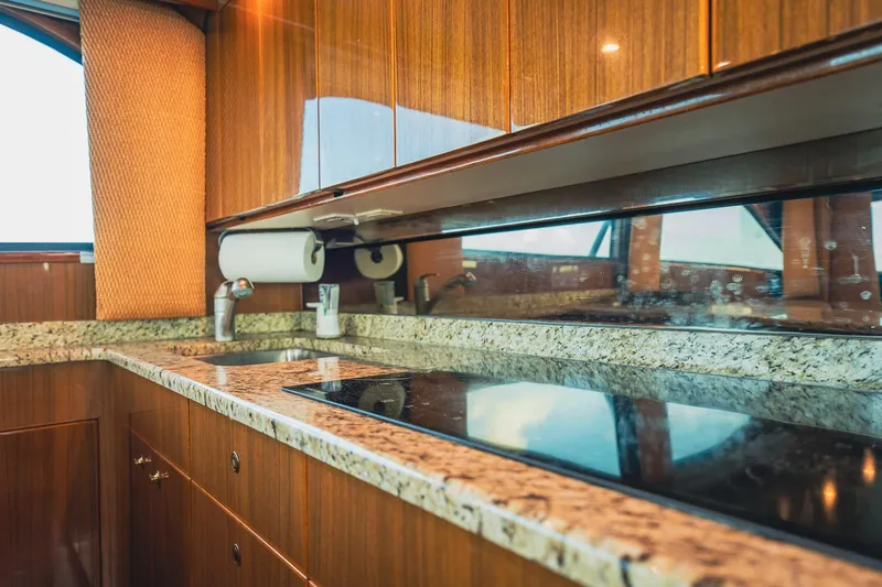 Slide: The Image of Luxurious kitchen interior of 2005 Viking 48 Convertible yacht with granite countertops. - 16