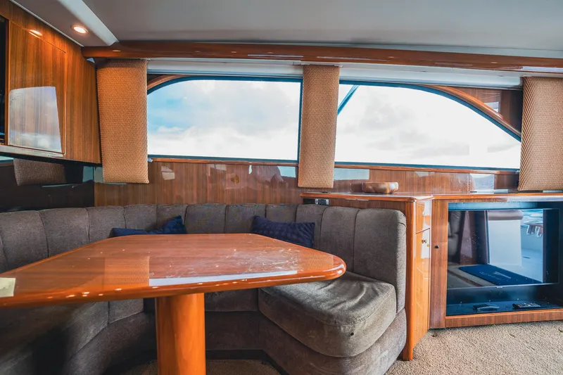 Slide: The Image of Interior of 2005 Viking 48 Convertible yacht with wooden table and plush seating. - 18