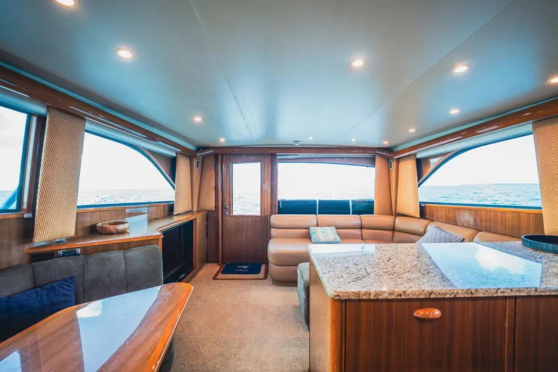 Slide: The Image of Luxurious interior of a 2005 Viking 48 Convertible yacht with elegant wood finishes. - 19