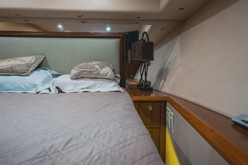 Slide: The Image of Luxurious bedroom interior of 2005 Viking 48 Convertible yacht with elegant bedding and lighting. - 23