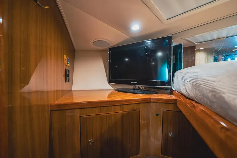 Slide: The Image of 2005 Viking 48 Convertible yacht interior with TV and wooden cabinetry. - 31