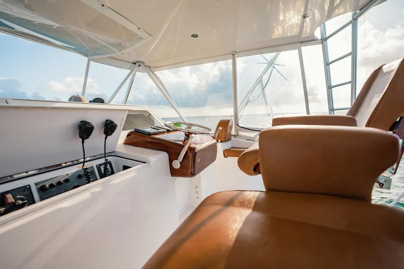 Slide: The Image of 2005 Viking 48 Convertible yacht cockpit with leather seats and control panel. - 47