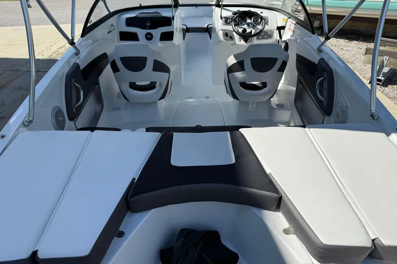 Slide: The Image of 2021 Tahoe 550 TS boat interior with seating and steering wheel, showcasing modern design. - 6