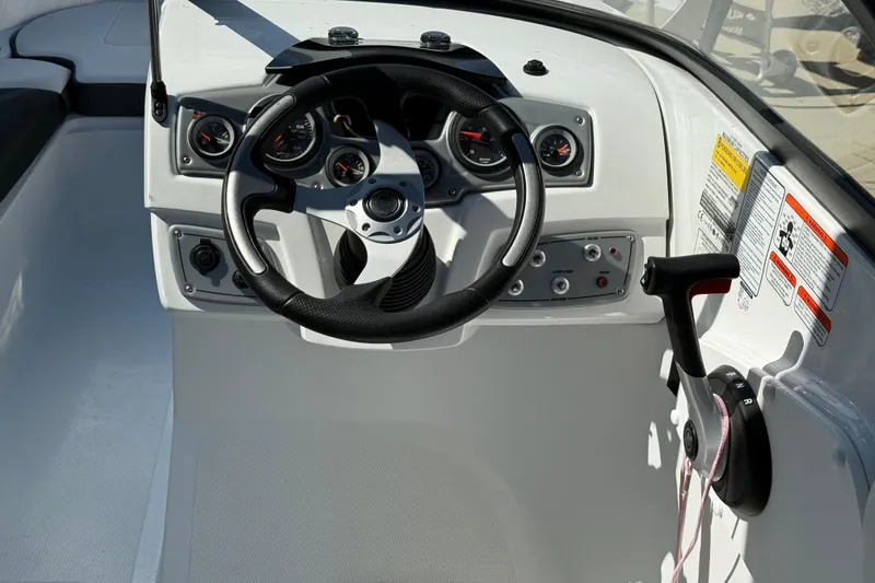 Slide: The Image of Steering console of 2021 Tahoe 550 TS boat with gauges and controls. - 8