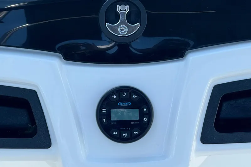 Slide: The Image of 2021 Tahoe 550 TS boat dashboard with Jensen audio system and anchor emblem. - 9
