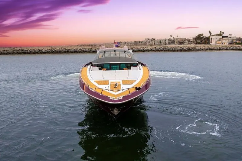 Slide: The Image of Luxurious 2011 Baia yacht cruising at sunset near coastal cityscape. - 12