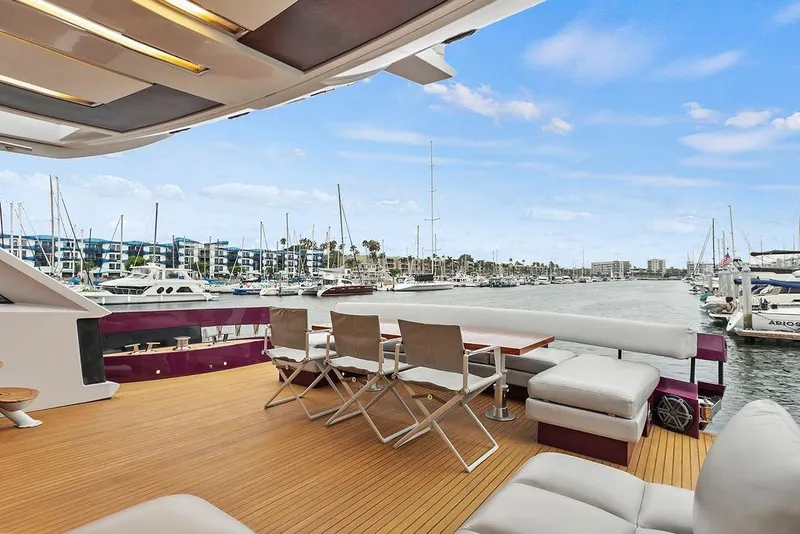 Slide: The Image of Luxurious 2011 Baia yacht deck with seating, overlooking marina and sailboats. - 16