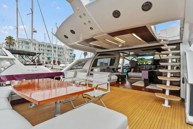 Slide: The Image of Luxurious 2011 Baia yacht with spacious deck, modern seating, and elegant wooden table. - 17