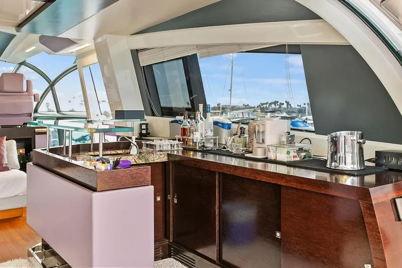 Slide: The Image of Luxurious interior of 2011 Baia yacht with elegant bar setup and scenic marina view. - 20