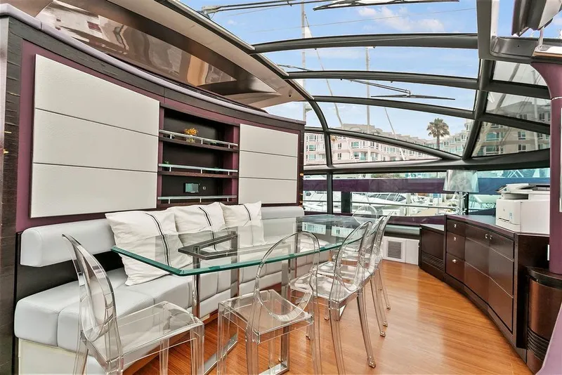 Slide: The Image of Luxurious 2011 Baia yacht interior with modern dining area and panoramic windows. - 27