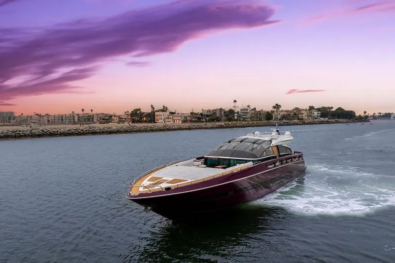 Slide: The Image of Luxury Baia yacht cruising at sunset, 2011 model, with vibrant sky and coastal backdrop. - 3