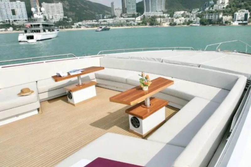 Slide: The Image of Luxurious 2011 Baia ONE HUNDRED yacht deck with seating, tables, and scenic coastal view. - 30