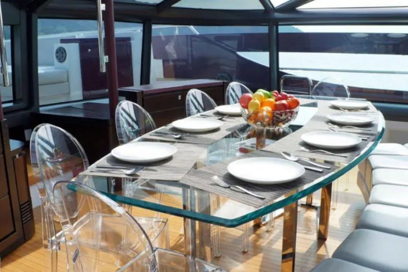 Slide: The Image of Luxurious dining area on 2011 Baia ONE HUNDRED yacht with glass table and fruit centerpiece. - 31