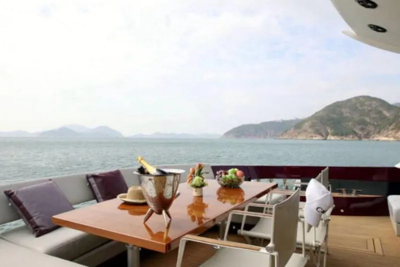 Slide: The Image of Luxurious Baia ONE HUNDRED yacht deck with ocean view, dining table, and champagne, 2011 model. - 38