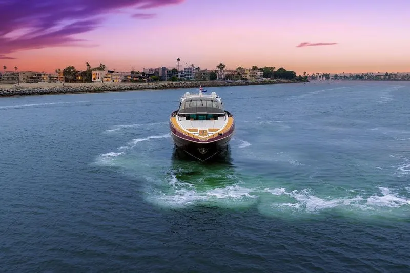 Slide: The Image of Luxurious 2011 Baia yacht cruising at sunset near coastal cityscape. - 5