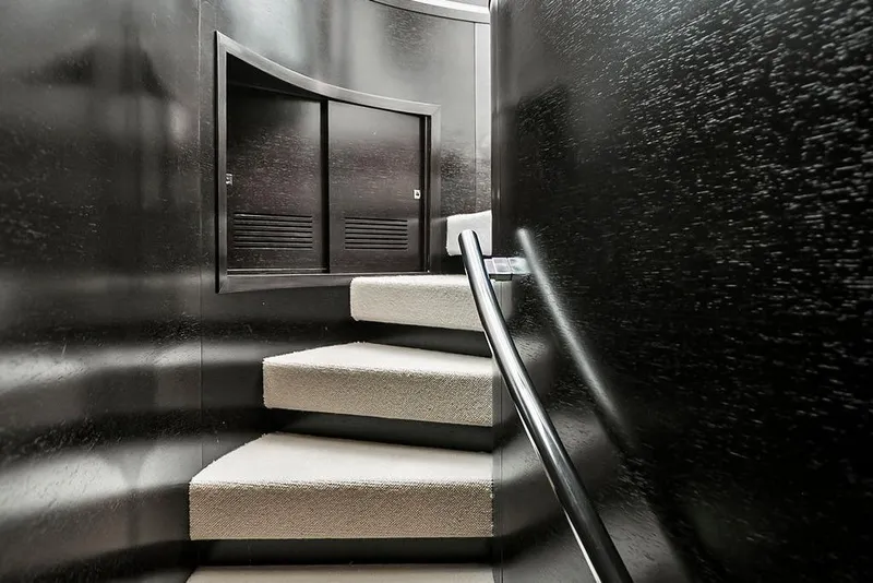 Slide: The Image of Curved staircase with black walls inside a 2011 Baia xxx yacht. - 51